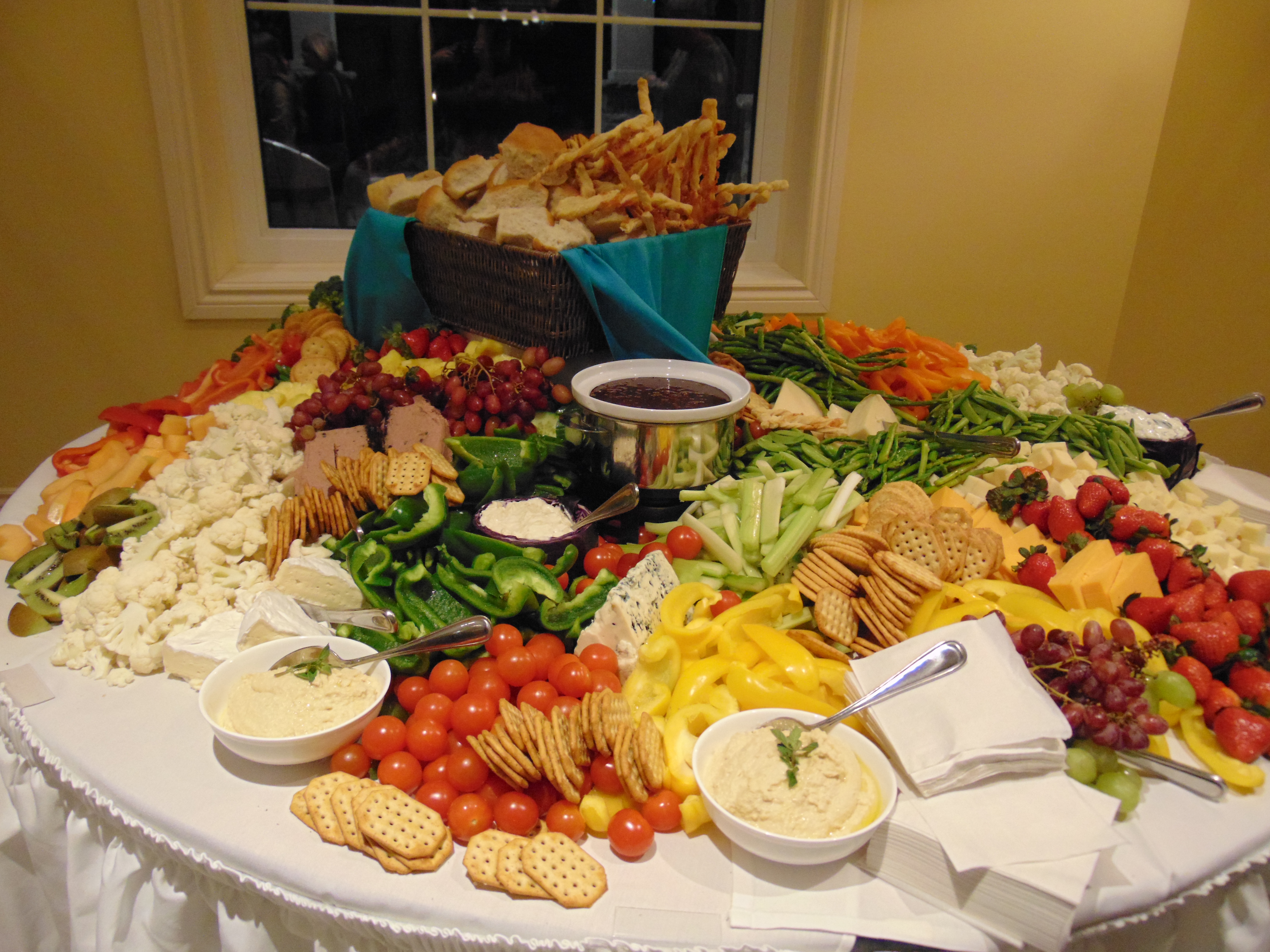 Orchard View by the Mississippi - Veggie, dip, crackers, cheese display on large round table. Food is our focus
